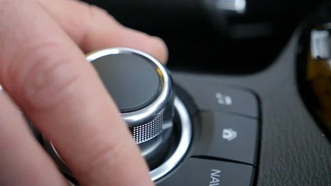 The man adjusts control panel in the car Stock Footage 87330671