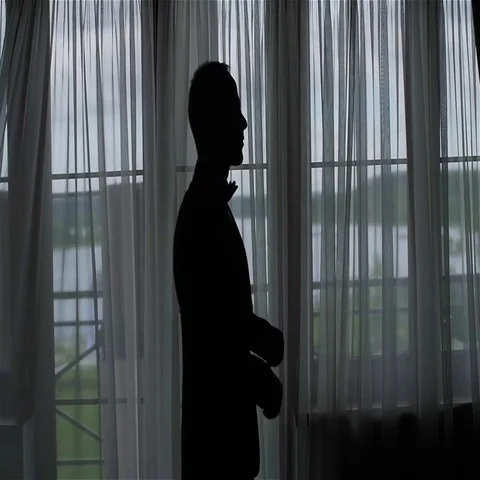 Man adjusts correct straightens black bow tie silhouette slow motion middle shot Stock Footage 69396080