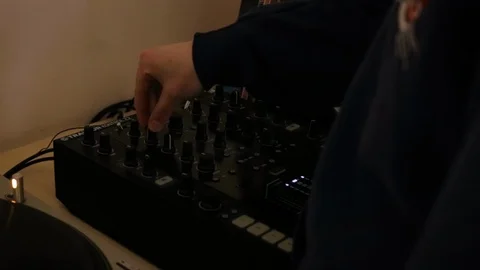 Man adjusts dj mixer equalizer (cool colors) Stock Footage 106026050