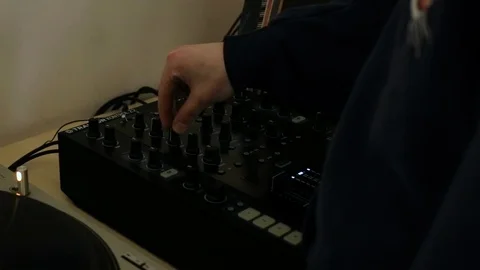 Man adjusts dj mixer equalizer (warm colors) Stock Footage 106026108