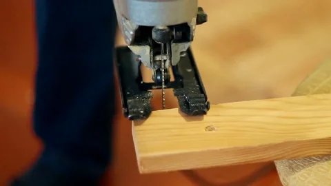 Man adjusts electric jigsaw Stock Footage 69214261