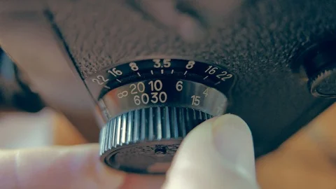 A man adjusts the focus of a camera Stock Footage 99740336