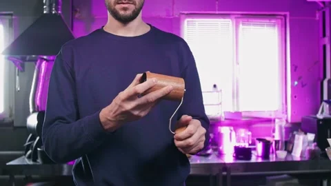 Man adjusts grind size on manual coffee grinder Stock-Footage 188092424