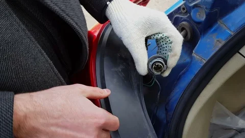 Man adjusts the headlight and tries to repair a light lamp Video stock 80527950