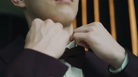 A man adjusts his shirt collar going to a meeting at the window Stock Footage 163892353