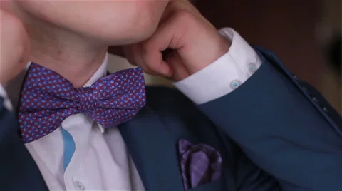 A man adjusts his tie.  Stock Footage 65336881