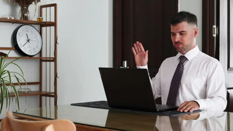 Man adjusts his tie before a video conference. Video stock 309541662
