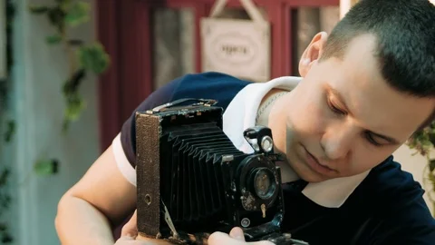 Man adjusts the an old retro camera close-up Stock Footage 89446470