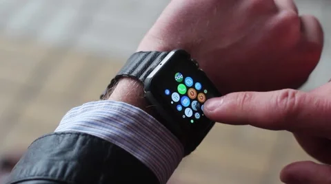 A Man Adjusts a Smart Watch. on the Colored Icons Are Visible. New Video stock 61179531