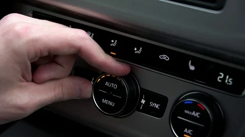 Man adjusts the temperature in the car Stock Footage 73940650
