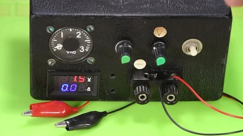 A man adjusts voltage while repairing a vintage power supply. Stock Footage 164880582