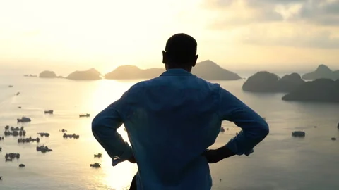 Man admire amazing sunset over bay at Ha Long Bay in Vietnam Stock Footage 163331655