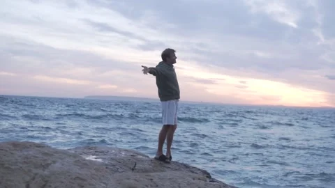 Man admire view and stretching arms in during sunset Stock Footage 254297477