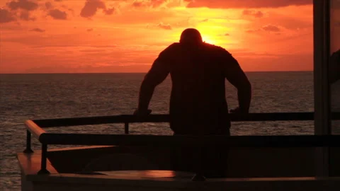 A man admires the sunset from the balcony Stock Footage 150495316