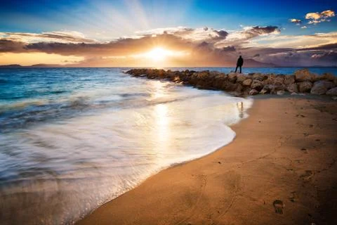 Man admiring the sunset over the beach Stock Photos