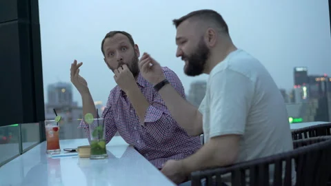 Man after alcohol arguing with each other on the building's roof Stock Footage 87563946