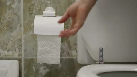 A man after constipation, pulls toilet paper. Stock Footage 94808472