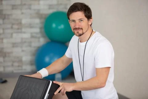 Man after doing step up jumps in health club Stock Photos