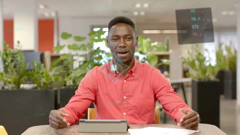 Man after glancing tablet speaking to camera, explaining business data, AI badge Stock Footage 332865953