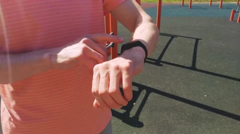 A man after a run measures the pulse on a fitness tracker Stock Footage 201813884
