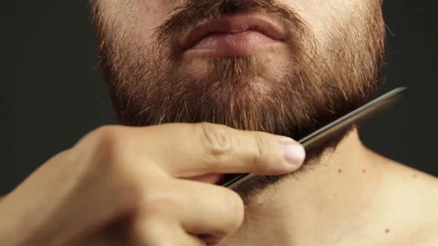 Man after shower brushing his beard Stock Footage 93079213
