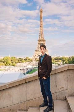 A man against the backdrop of the Eiffel tower in Paris, France. Stock Photos