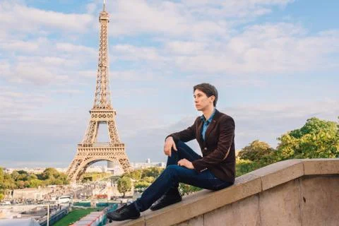 A man against the backdrop of the Eiffel tower in Paris, France. Stock Photos