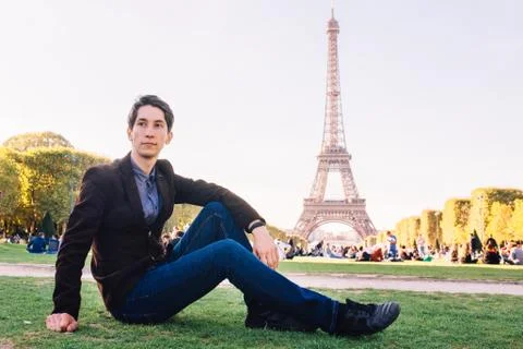 A man against the backdrop of the Eiffel tower in Paris, France. 写真素材