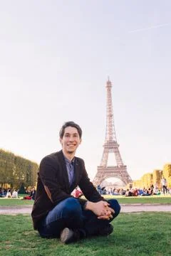 A man against the backdrop of the Eiffel tower in Paris, France. Stock Photos
