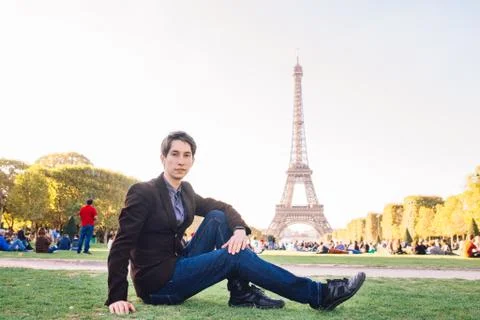 A man against the backdrop of the Eiffel tower in Paris, France. Stock Photos