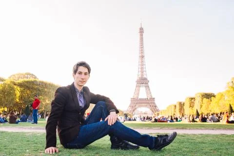 A man against the backdrop of the Eiffel tower in Paris, France. Stock Photos