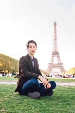 A man against the backdrop of the Eiffel tower in Paris, France. 写真素材