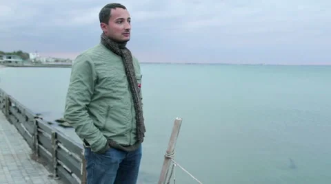 Man Against The Backdrop Of An Overcast Sea Stock Footage 60211929