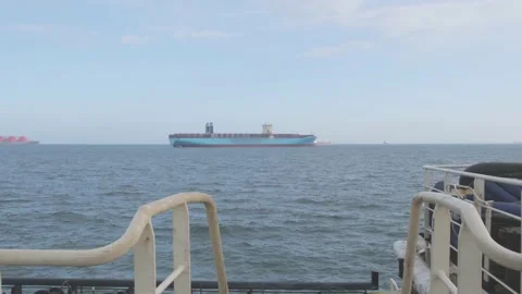 Man against distant MaerskLine container ship standing idle Stock Footage 131604767