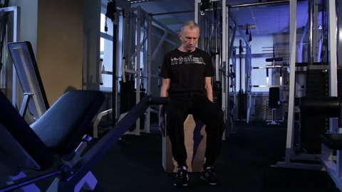 A man of the age performs joint gymnastics for the neck in the gym.Tilts head Stock Footage 115199184