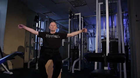 A man of the age performs joint gymnastics for the wrist in the gym.wrist Stock Footage 115207024