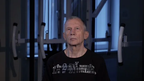A man of the age performs joint gymnastics for the neck in the gym.Sideways head Video stock 115506667