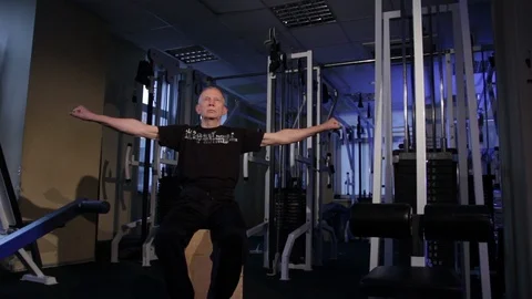 A man of the age performs joint gymnastics for the fingers in the gym.Clenching Video stock 115876131