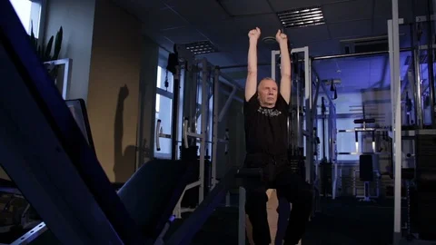 A man of the age performs joint gymnastics for the fingers in the gym.Clenching Stock Footage 115876320