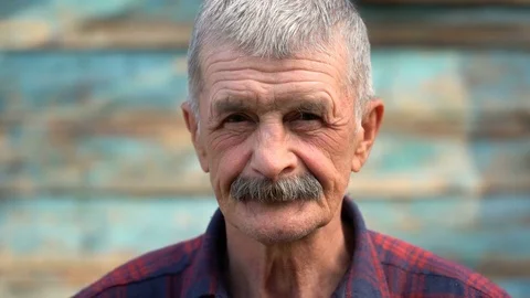 A man of age waved his hand at the camera Stock Footage 75945054