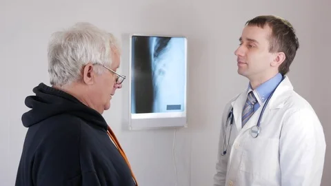 A man aged at a doctor's reception. Coughs and talks about health problems. The Stock Footage 73641695