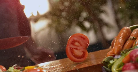 Man aggressively cutting a tomato Stock Footage 311833169