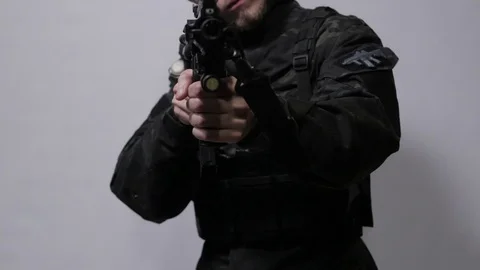 A man aiming with submachine gun straight at the camera Stock Footage 119083016