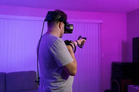 Man aiming at target during VR simulation session Stock Photos