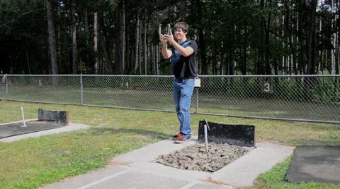 Man aims throws horseshoe Stock Footage 31552346