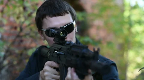 The man aims from the weapon front view Stock Footage 60389260