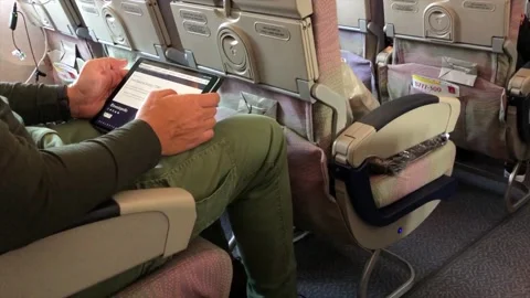 Man in the airplane using tablet Stock Footage 141464632