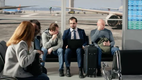 Man in airport lounge checking departure board for timetable data Stock Footage 333652853