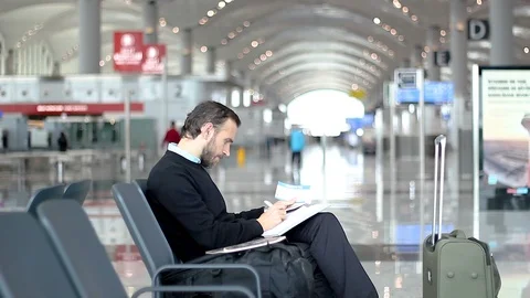 Man at the airport takes notes Stock Footage 99064818