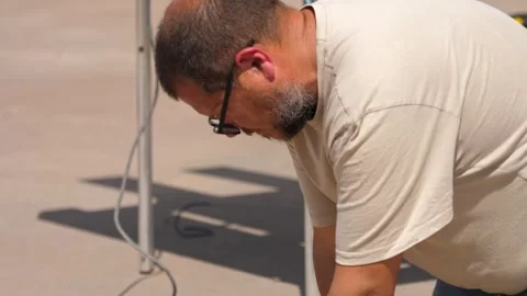 Man aligns two wood pieces, then uses a power drill  Video stock 308019059